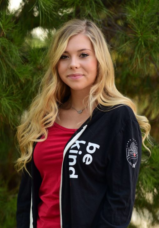 Woman wearing CURA's 'be kind' hoodie.